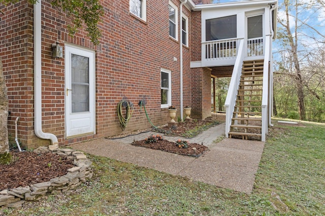 exterior space with brick siding and stairs