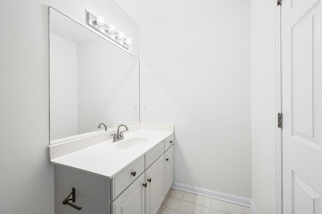 bathroom with baseboards, tile patterned floors, and vanity