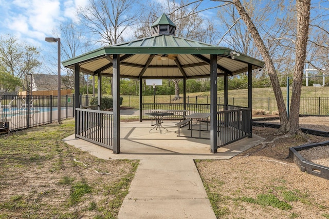 surrounding community featuring a patio area, a gazebo, fence, and a pool