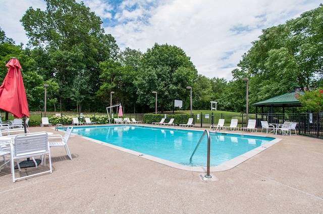 pool with fence and a patio area