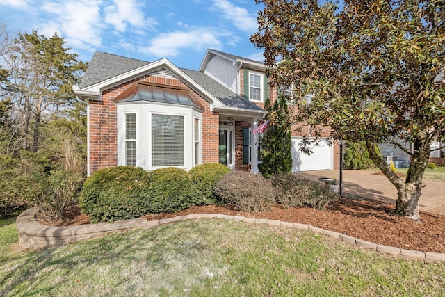 view of front of home with an attached garage, brick siding, a shingled roof, and concrete driveway