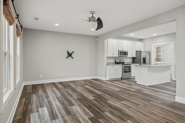 kitchen with light countertops, a ceiling fan, dark wood-style floors, stainless steel appliances, and visible vents