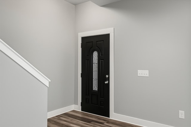 entrance foyer with baseboards and dark wood-type flooring