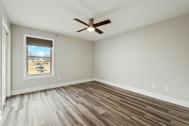 unfurnished room featuring baseboards, ceiling fan, and wood finished floors