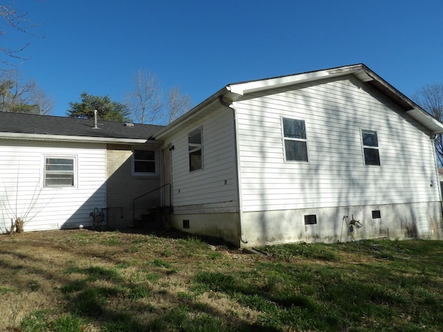 back of house featuring crawl space and a yard