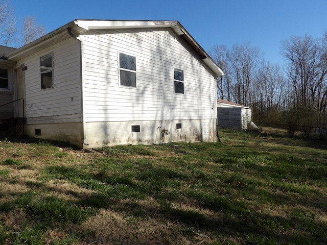 view of home's exterior featuring crawl space and a lawn