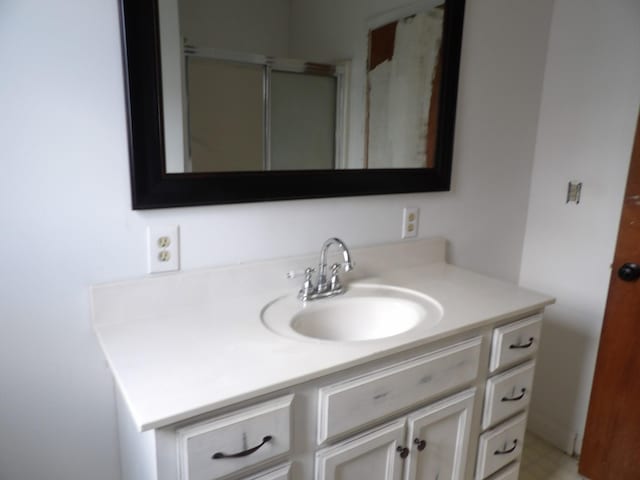 bathroom with a stall shower and vanity