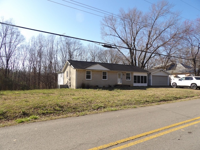 view of front of house featuring a front yard and a garage