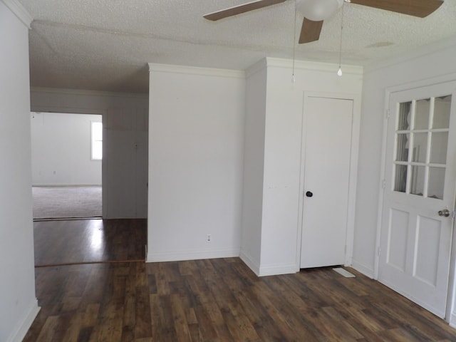unfurnished room featuring a textured ceiling, ornamental molding, wood finished floors, and a ceiling fan