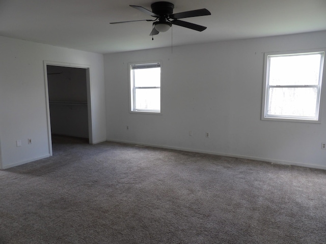 unfurnished bedroom featuring baseboards, a closet, carpet, and a ceiling fan