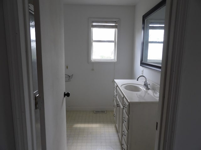 bathroom featuring tile patterned floors, vanity, baseboards, and visible vents