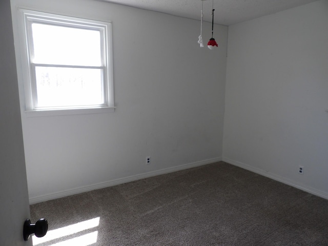 carpeted empty room with baseboards