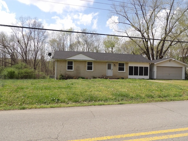 single story home with an attached garage and a front lawn