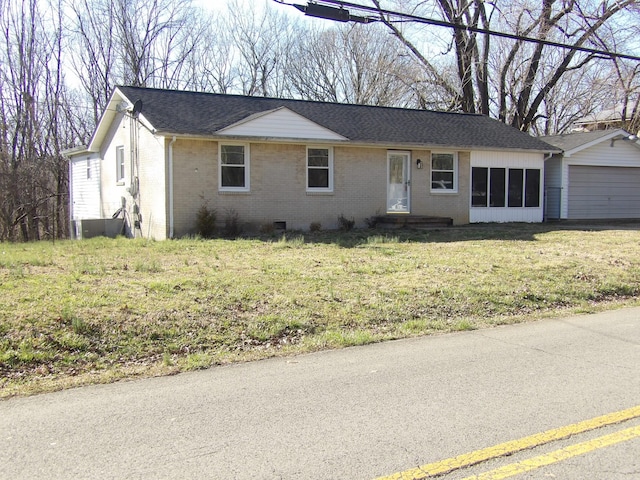 ranch-style house with a front lawn, a shingled roof, and brick siding