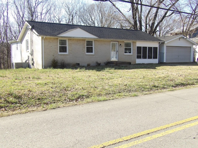 single story home featuring brick siding, a front yard, a garage, and a shingled roof