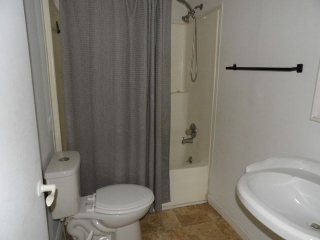 bathroom featuring shower / bath combination with curtain and toilet