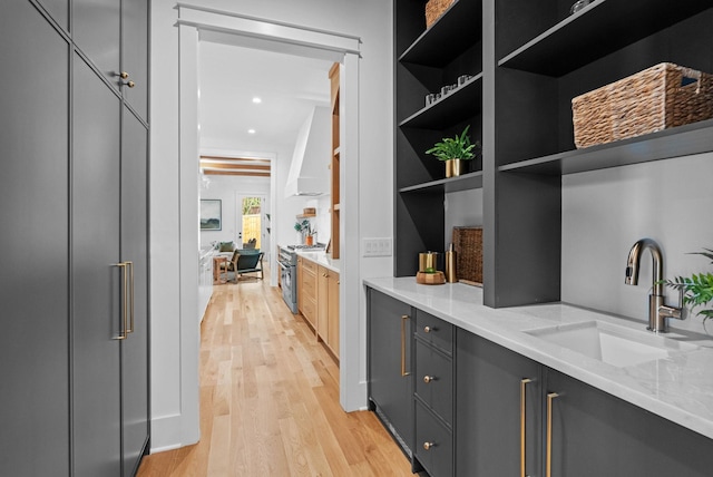 3411 Richards St, Nashville, TN 37215 - interior space with wall chimney range hood, light wood-type flooring, high end range, and a sink