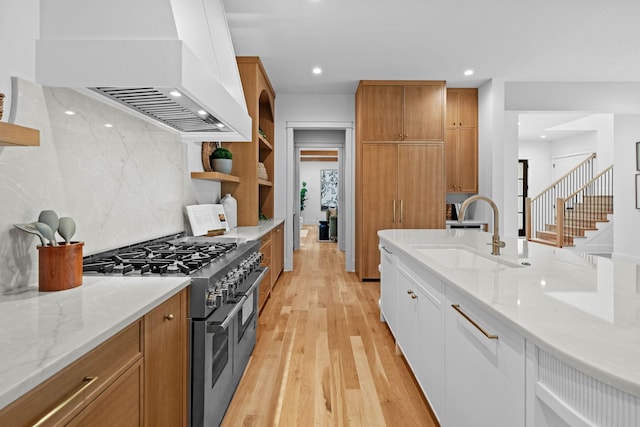 3411 Richards St, Nashville, TN 37215 - kitchen with double oven range, custom range hood, a sink, light stone counters, and light wood-style flooring