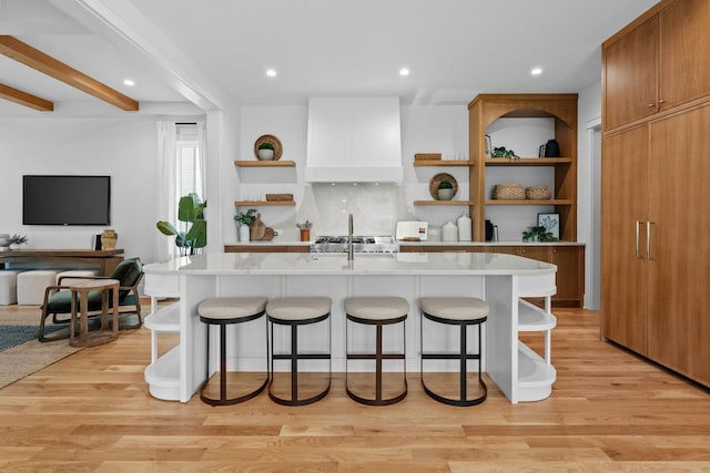 3411 Richards St, Nashville, TN 37215 - kitchen with light wood-style floors, a kitchen bar, open shelves, and custom exhaust hood