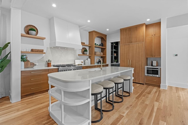 3411 Richards St, Nashville, TN 37215 - kitchen featuring brown cabinets, custom range hood, light wood-style floors, and open shelves