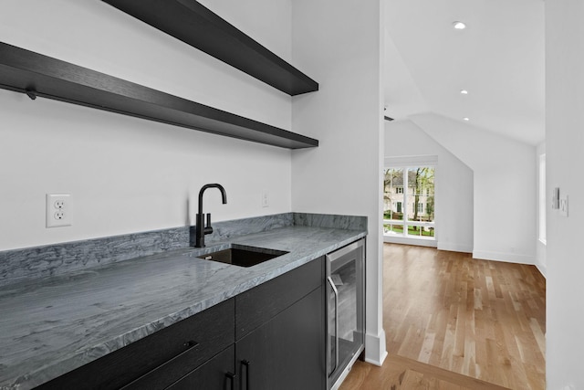 3411 Richards St, Nashville, TN 37215 - kitchen featuring open shelves, dark cabinetry, wine cooler, a sink, and light wood-style flooring