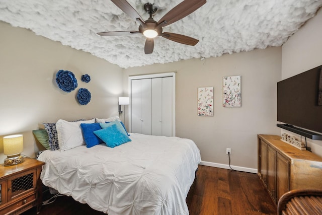 bedroom featuring baseboards, a closet, ceiling fan, and wood finished floors