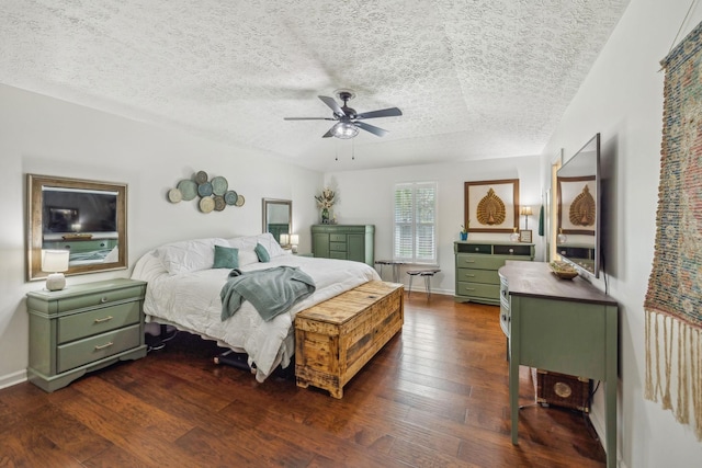 bedroom with a textured ceiling, dark wood-style floors, baseboards, and a ceiling fan