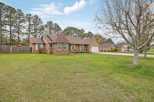 view of front of house with fence, a garage, concrete driveway, a front yard, and brick siding