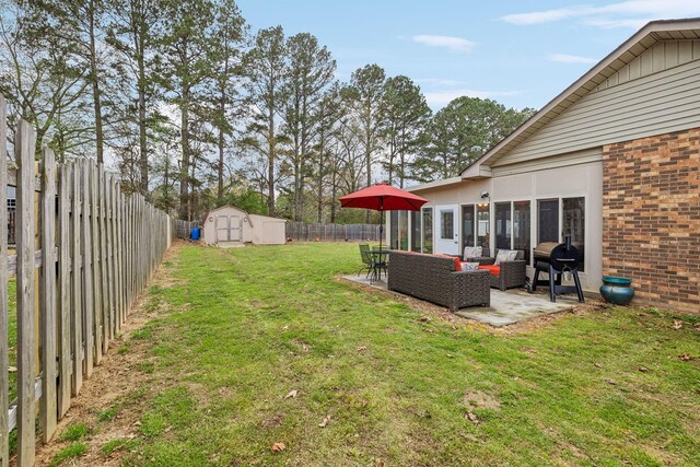 view of yard featuring an outbuilding, a fenced backyard, an outdoor hangout area, and a patio area
