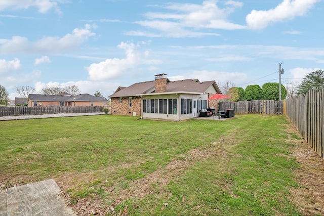 view of yard featuring a fenced backyard and a sunroom