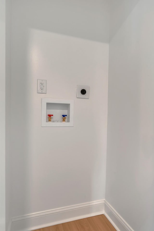 laundry room with hookup for an electric dryer, hookup for a washing machine, baseboards, light wood-style flooring, and laundry area