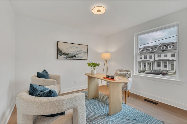 office featuring wood finished floors, baseboards, and visible vents