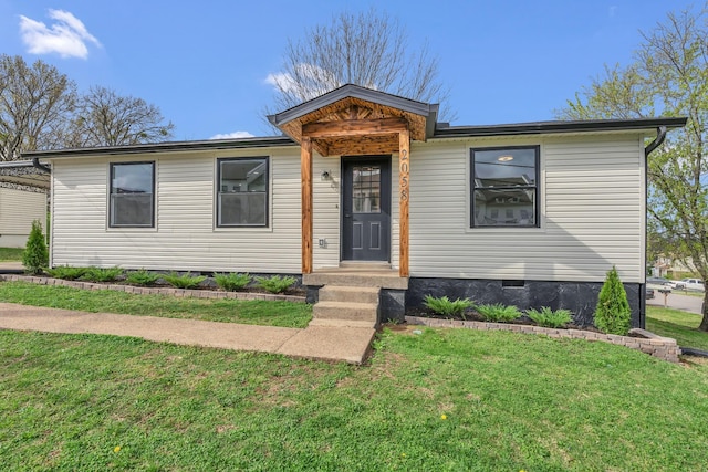 view of front of property with crawl space and a front lawn