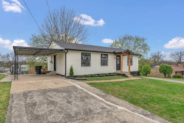 view of front of home with driveway, a carport, and a front lawn