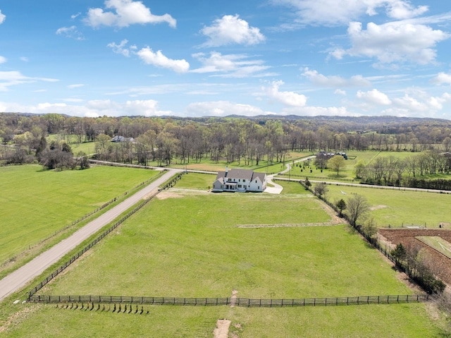 drone / aerial view featuring a wooded view and a rural view
