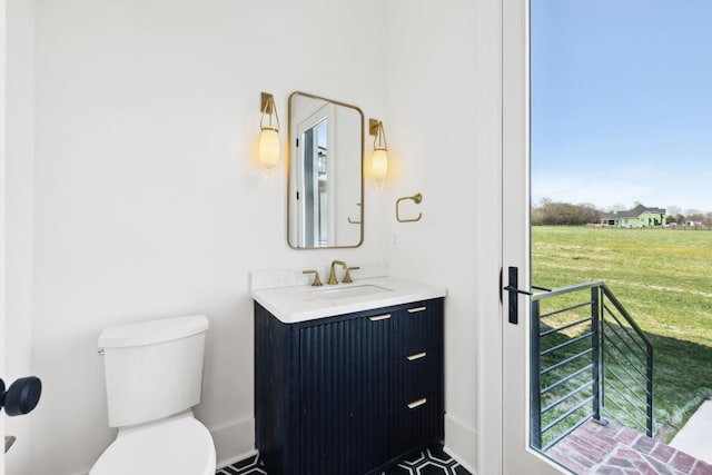 bathroom featuring toilet and vanity