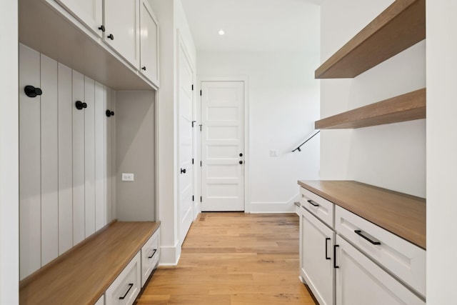 mudroom with light wood finished floors, baseboards, and recessed lighting