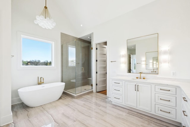 full bath with a shower stall, high vaulted ceiling, a freestanding tub, and vanity