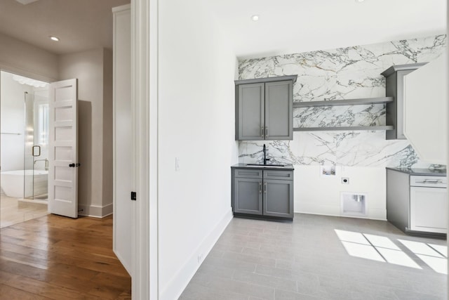 interior space with a sink, baseboards, and recessed lighting