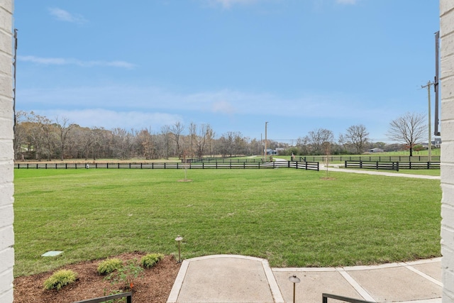 view of yard featuring fence and a rural view