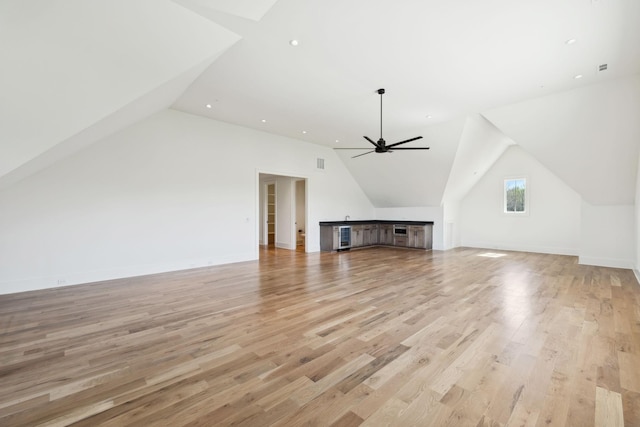 additional living space with light wood finished floors, baseboards, lofted ceiling, and ceiling fan