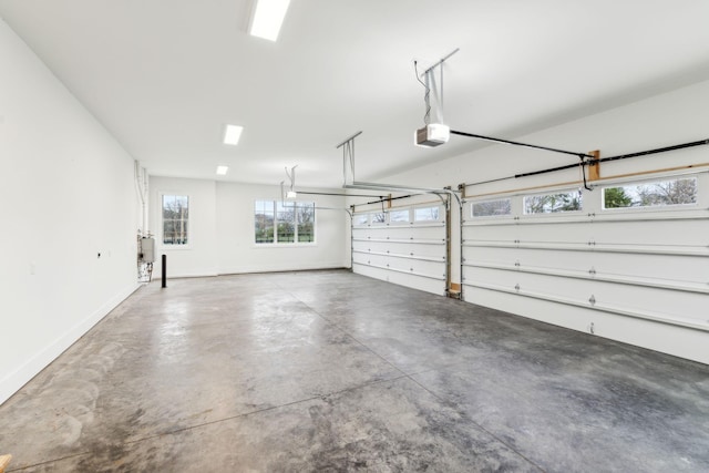 garage featuring a garage door opener and baseboards