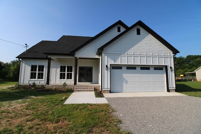2111 Horton Way, Lewisburg, TN 37091 - view of front facade with board and batten siding, an attached garage, gravel driveway, and a front yard