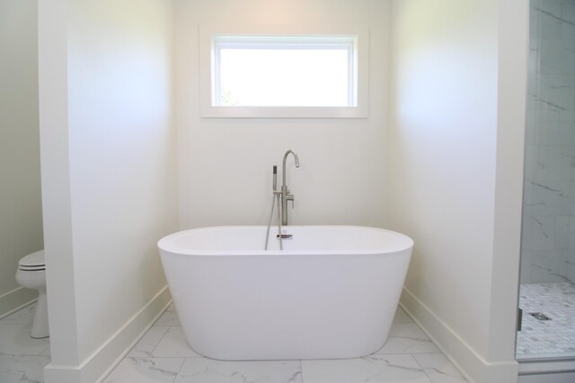 2111 Horton Way, Lewisburg, TN 37091 - bathroom featuring marble look tiles, a soaking tub, and baseboards