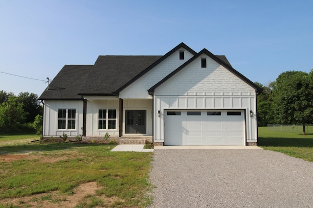 2111 Horton Way, Lewisburg, TN 37091 - view of front of property featuring board and batten siding, gravel driveway, a front lawn, and an attached garage