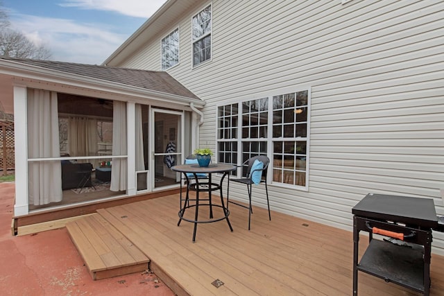 wooden deck with a sunroom
