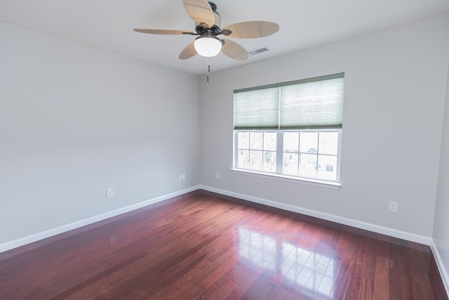 unfurnished room with baseboards, ceiling fan, visible vents, and wood finished floors