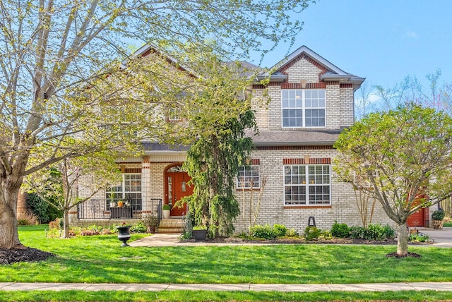 view of front of house featuring brick siding, a porch, and a front lawn