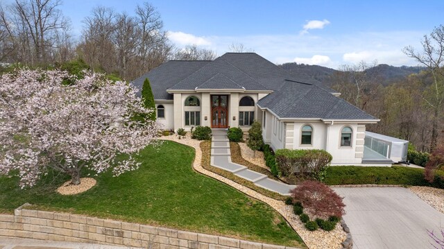 720 Valhalla Ln, Brentwood, TN 37027 - french country home with a front lawn, stucco siding, a shingled roof, and concrete driveway