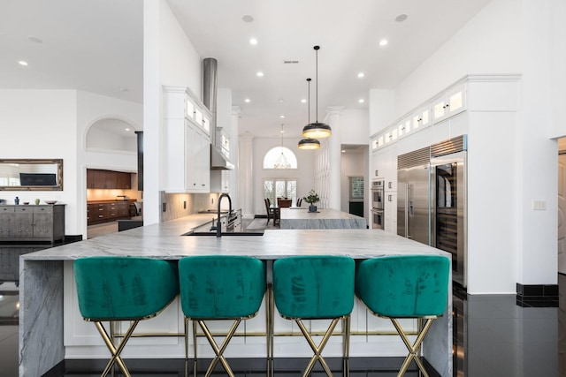720 Valhalla Ln, Brentwood, TN 37027 - kitchen with recessed lighting, a peninsula, glass insert cabinets, white cabinets, and a sink